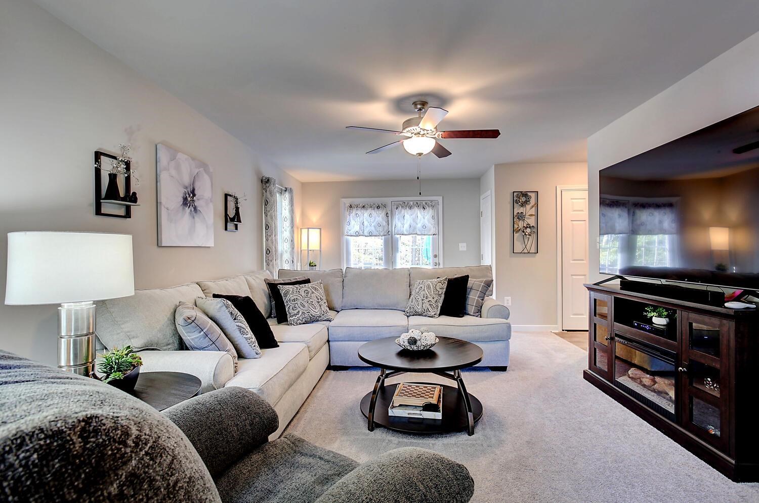 6144 Courthouse Road Louisa, VA 23093 - Photo 3 of 23 a living room with furniture a flat screen tv and a lamp