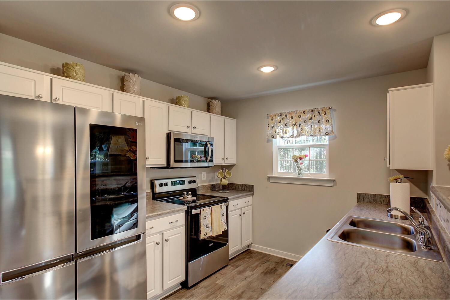 6144 Courthouse Road Louisa, VA 23093 - Photo 4 of 23 a kitchen with a refrigerator stove and a sink