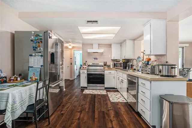 a kitchen with a sink and a stove top oven