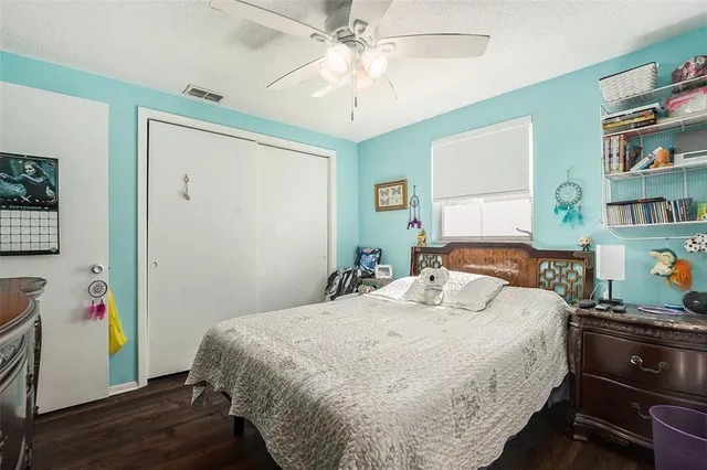 a bedroom with a bed and a bookshelf