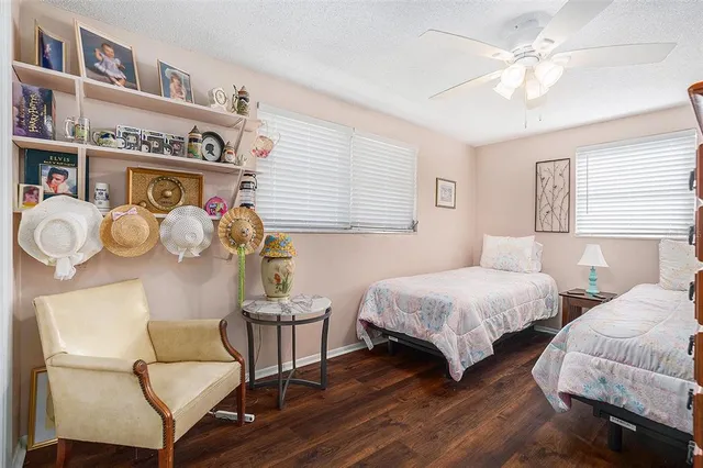 a bedroom with two beds and a chandelier