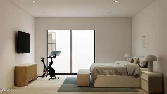 a bedroom with a bed and a flat screen tv