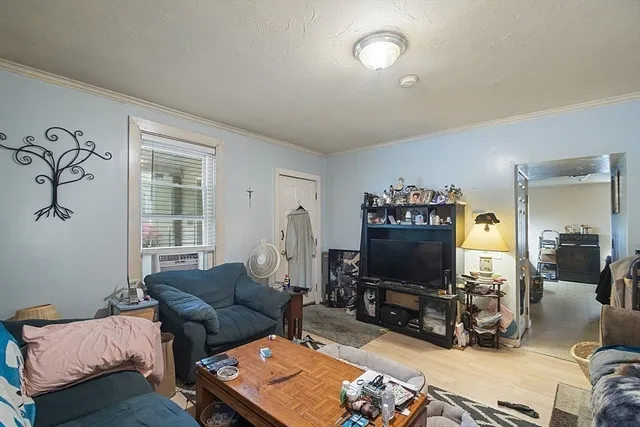 a living room with furniture a flat screen tv and a large window