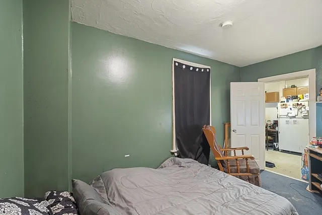 a bedroom with a bed and a chair