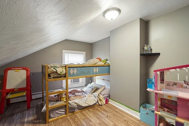 a bedroom with furniture and a flat screen tv