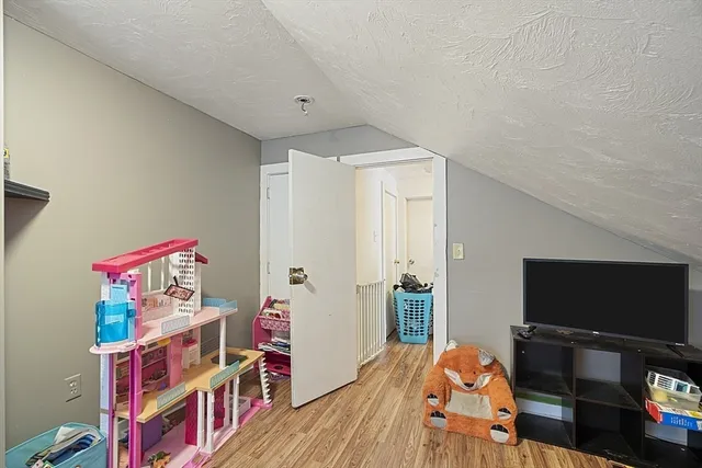 a bed sitting in a bedroom next to a window