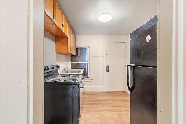 a kitchen with stainless steel appliances granite countertop a refrigerator a stove and a sink