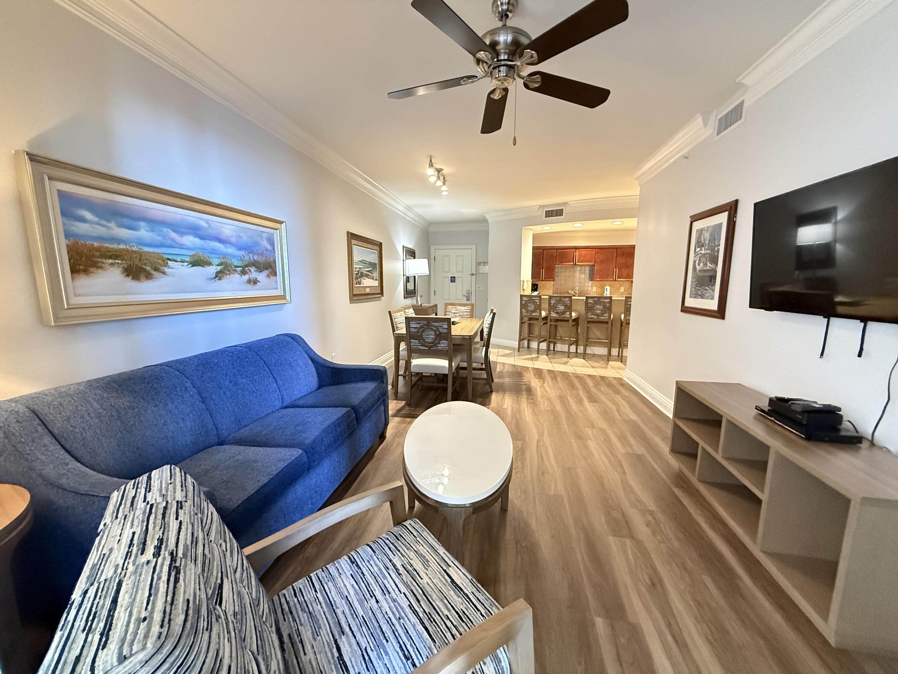 10 Harbor Boulevard, Unit E802B Destin, FL 32541 - Photo 2 of 25 a living room with furniture and a flat screen tv