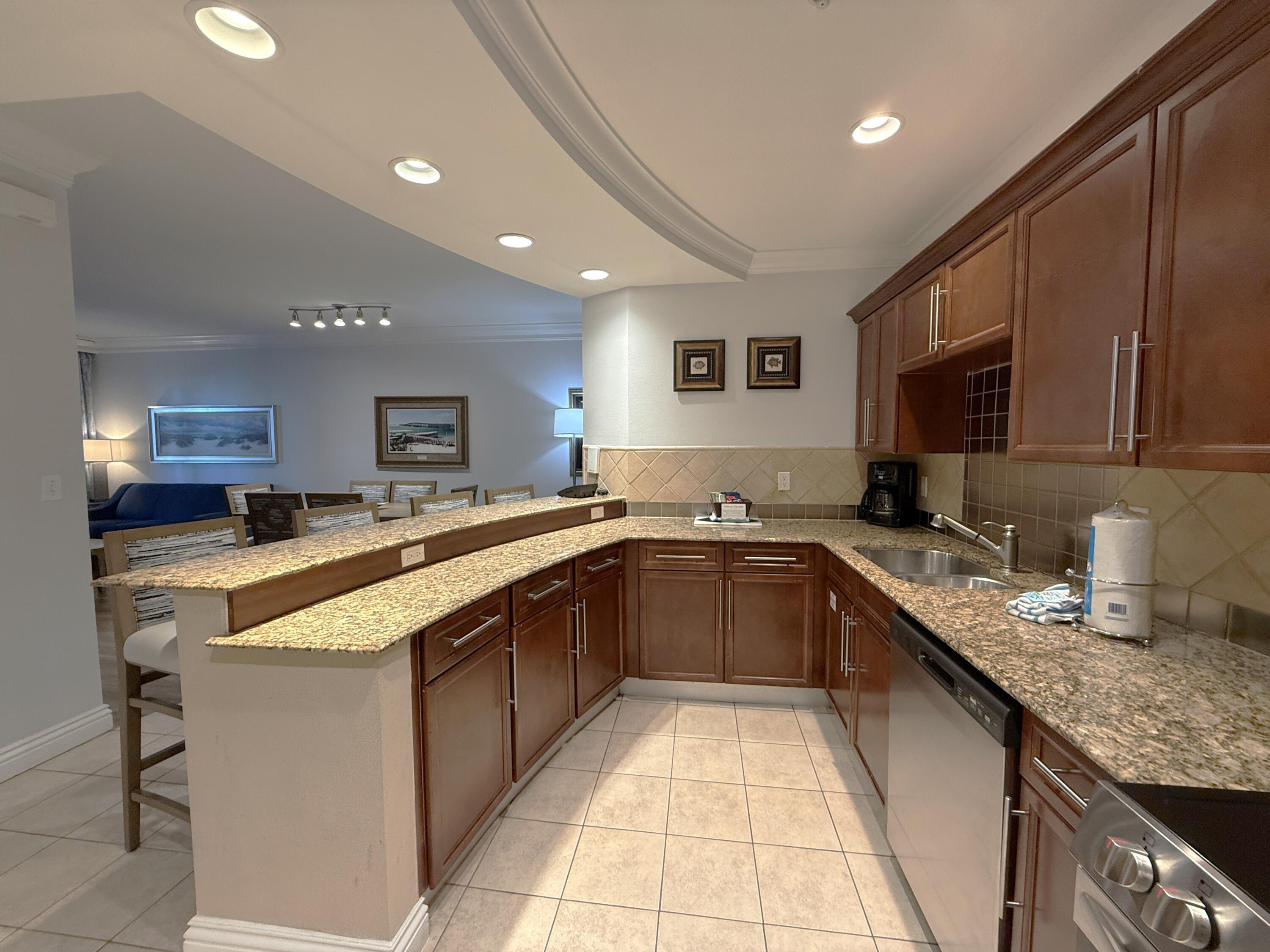 10 Harbor Boulevard, Unit E802B Destin, FL 32541 - Photo 5 of 25 a kitchen with a sink and cabinets