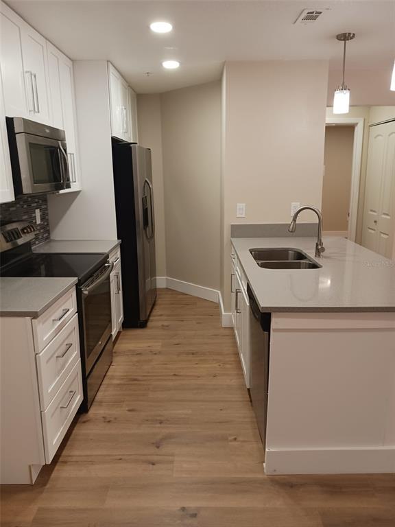 623 Dory Lane, Unit 306 Altamonte Springs, FL 32714 - Photo 15 of 21 a kitchen with a sink stove and refrigerator