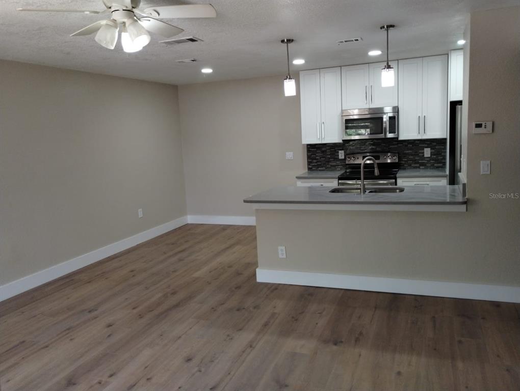 623 Dory Lane, Unit 306 Altamonte Springs, FL 32714 - Photo 16 of 21 a view of kitchen with cabinets and wooden floor