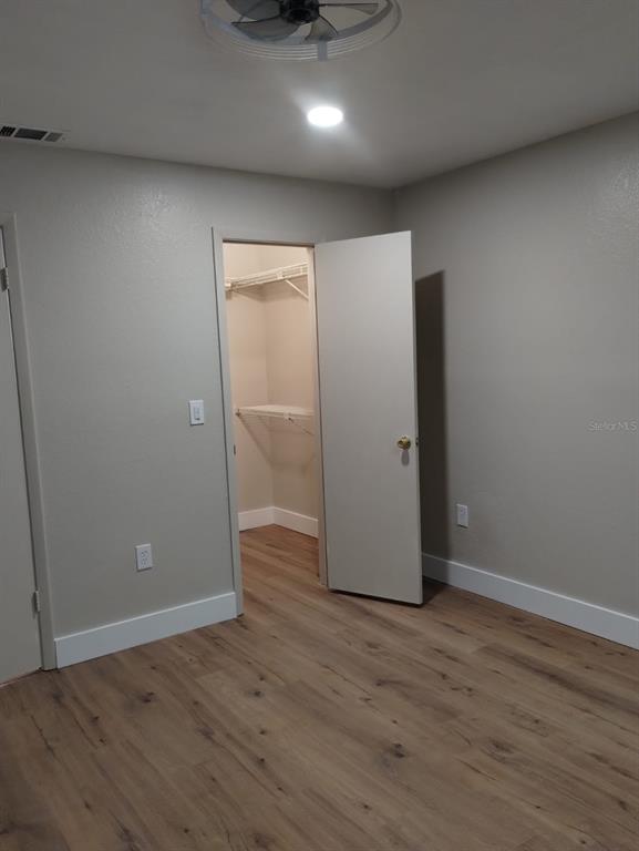 623 Dory Lane, Unit 306 Altamonte Springs, FL 32714 - Photo 19 of 21 an empty room with wooden floor and windows