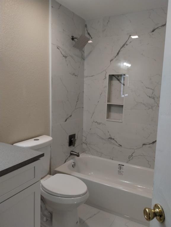 623 Dory Lane, Unit 306 Altamonte Springs, FL 32714 - Photo 21 of 21 a bathroom with a toilet a sink and bathtub