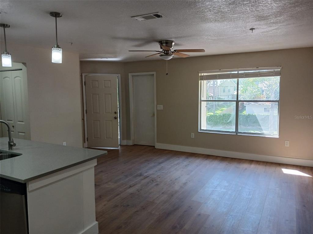 623 Dory Lane, Unit 306 Altamonte Springs, FL 32714 - Photo 8 of 21 a view of an empty room with a window and wooden floor
