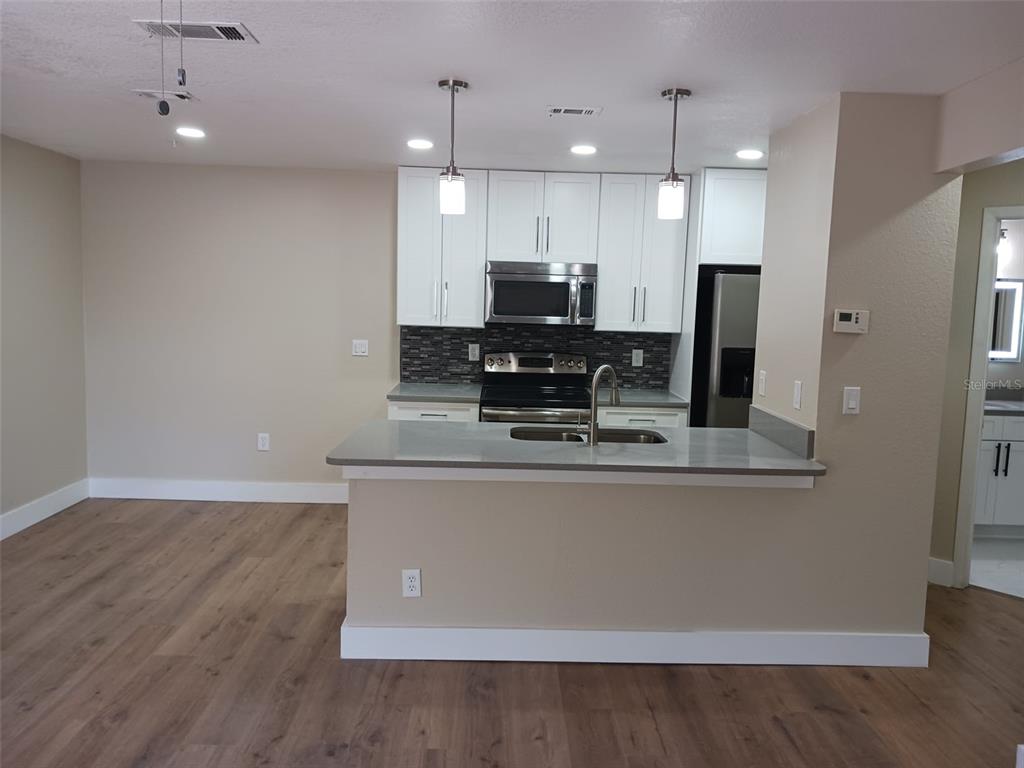 623 Dory Lane, Unit 306 Altamonte Springs, FL 32714 - Photo 10 of 21 a view of kitchen with stainless steel appliances granite countertop refrigerator sink and stove