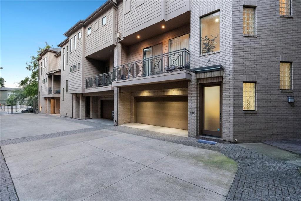 4023 Rawlins Street, Unit 103 Dallas, TX 75219 - Photo 1 of 1 a front view of a house with yard and garage