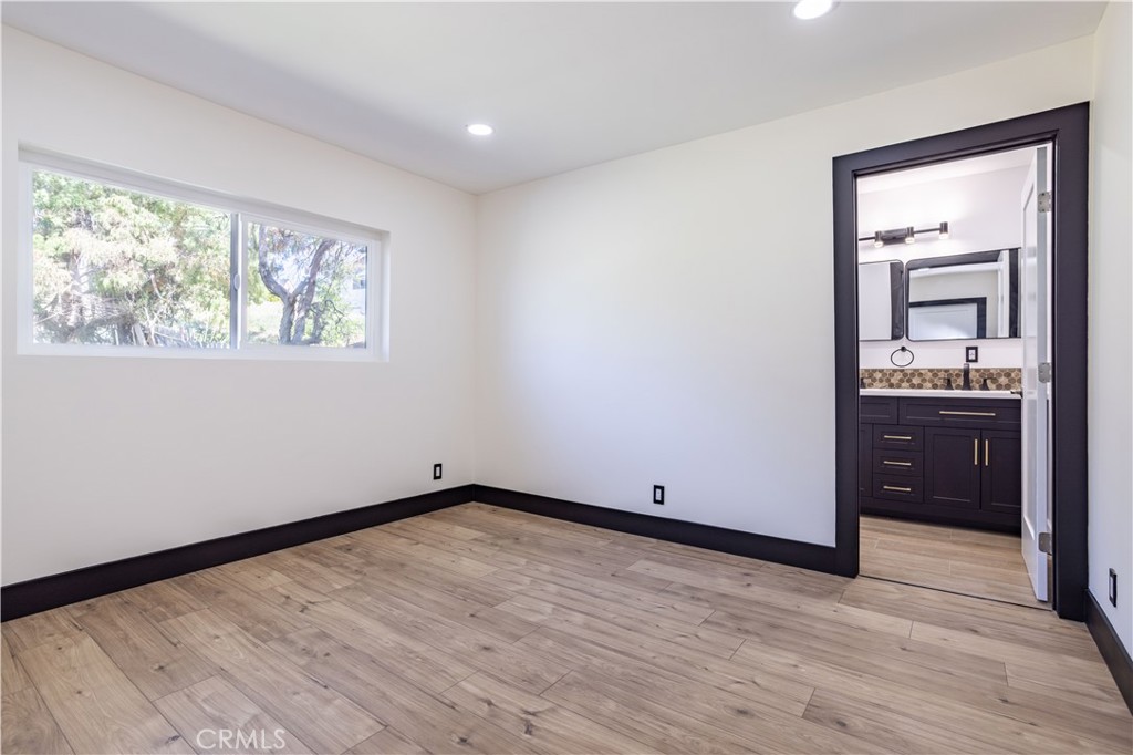 42640 Ranch Club Road Lake Hughes, CA 93532 - Photo 12 of 27 wooden floor in an empty room with a window