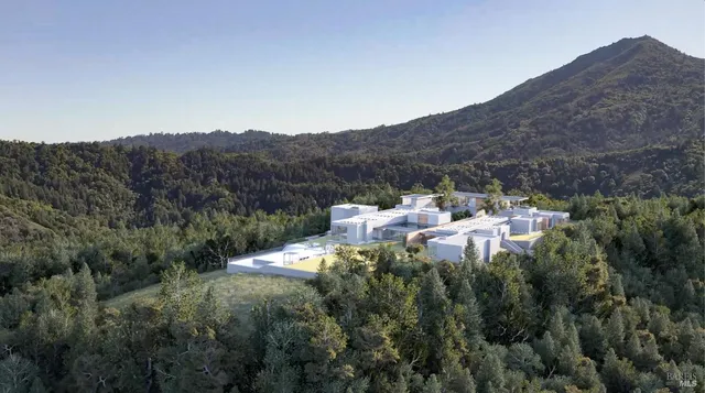 a view of a lush green hillside and a building