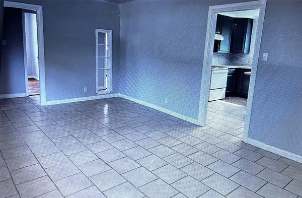 an empty room with a kitchen