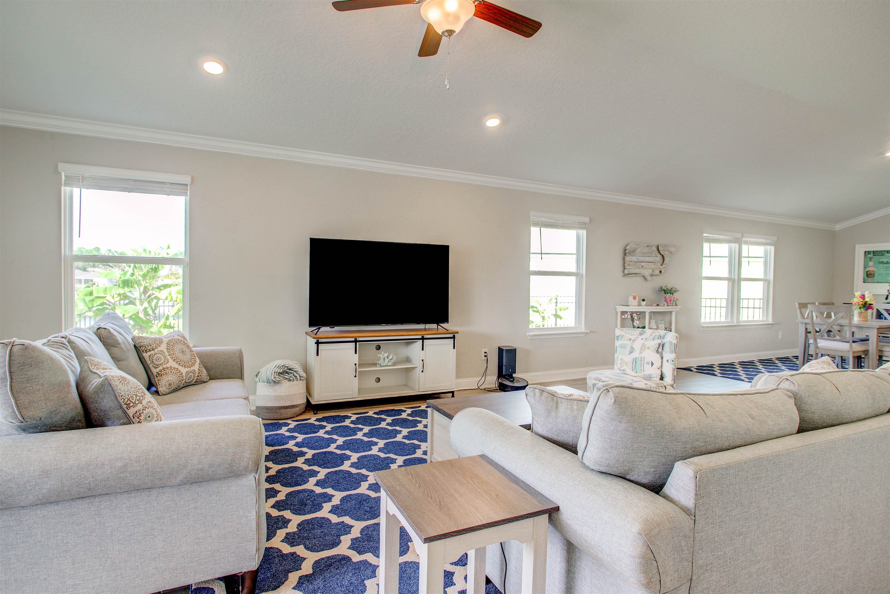 130 Huesca Court St. Augustine, FL 32084 - Photo 12 of 63 a living room with furniture a flat screen tv and a large window
