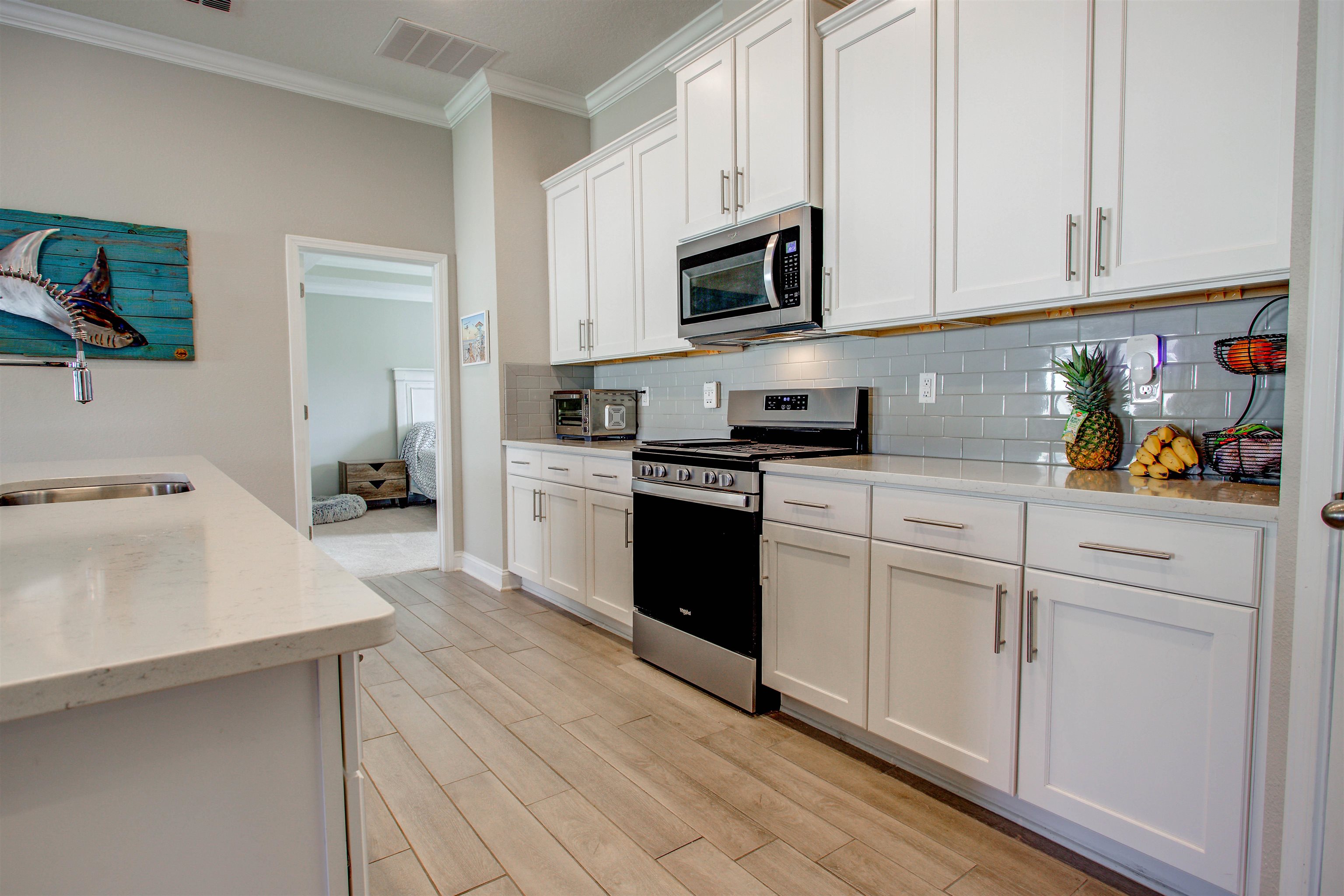 130 Huesca Court St. Augustine, FL 32084 - Photo 16 of 63 a kitchen with stainless steel appliances granite countertop white cabinets sink and stove