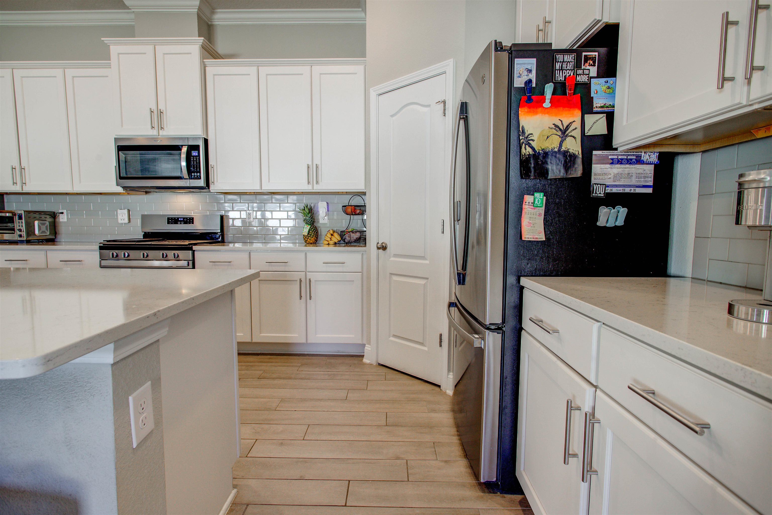 130 Huesca Court St. Augustine, FL 32084 - Photo 18 of 63 a kitchen with white cabinets and appliances