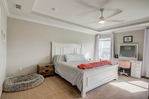a bedroom with a bed and a chandelier