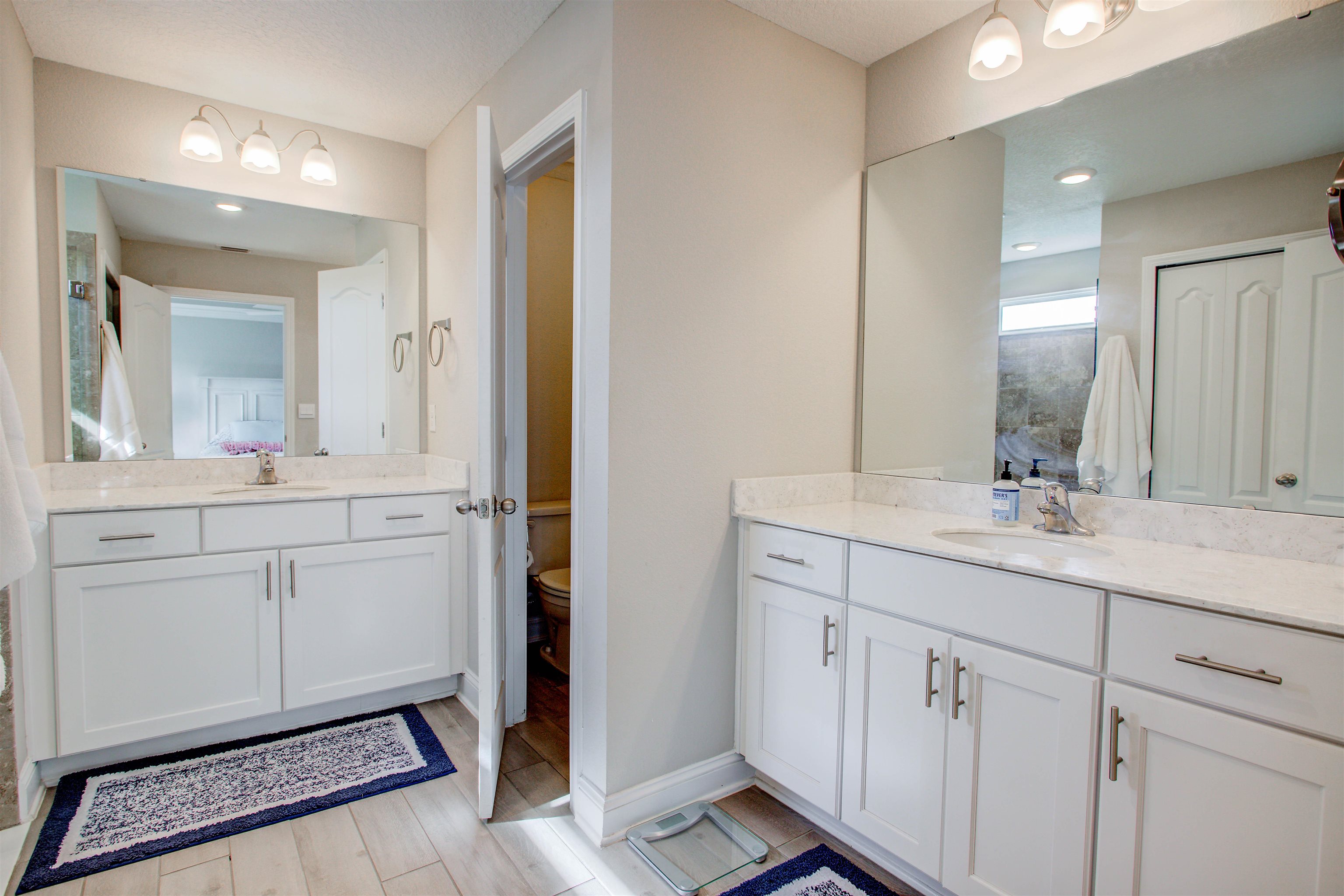 130 Huesca Court St. Augustine, FL 32084 - Photo 23 of 63 a bathroom with a double vanity sink and mirror