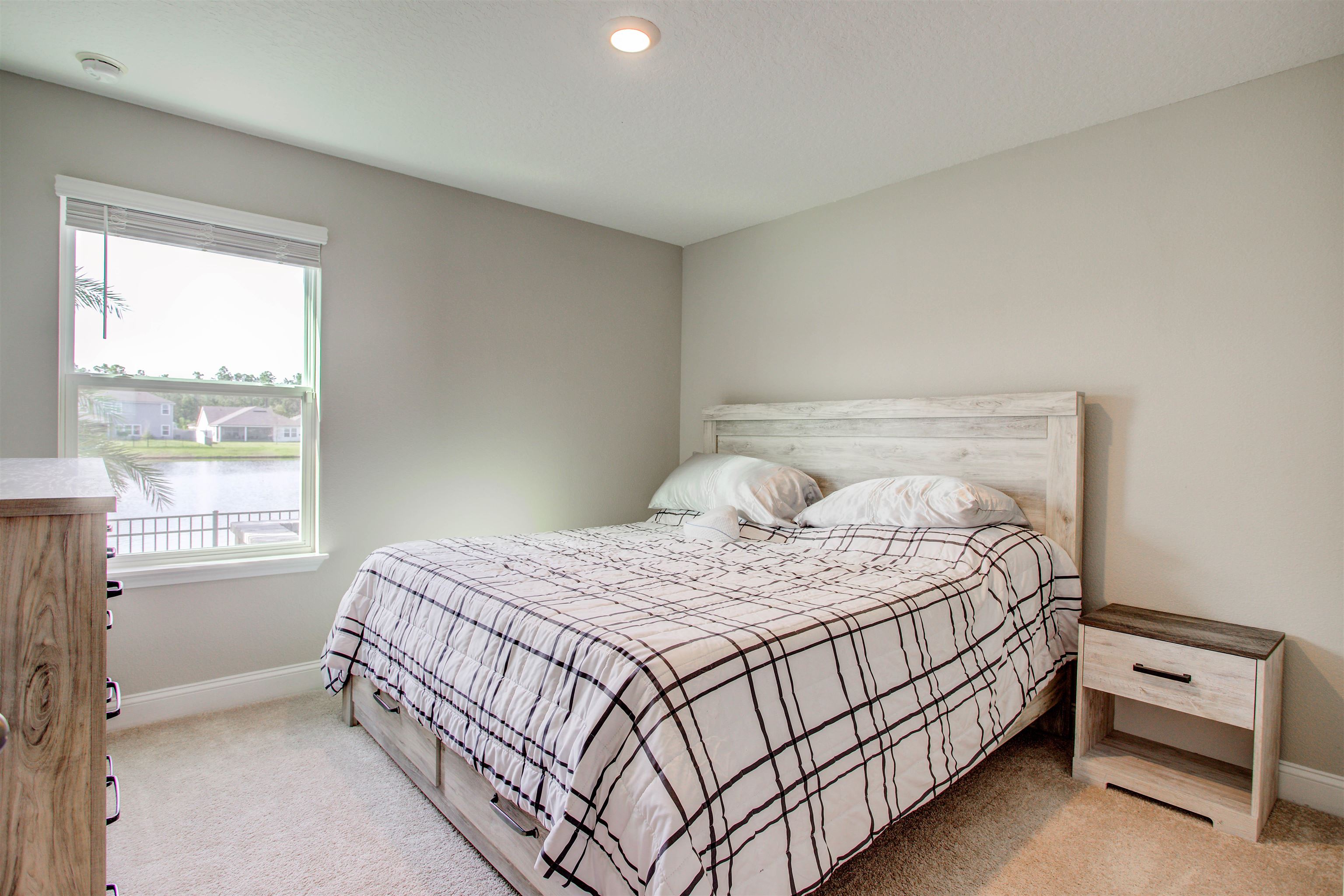 130 Huesca Court St. Augustine, FL 32084 - Photo 26 of 63 Bedroom featuring light carpet, a water view, and recessed lighting