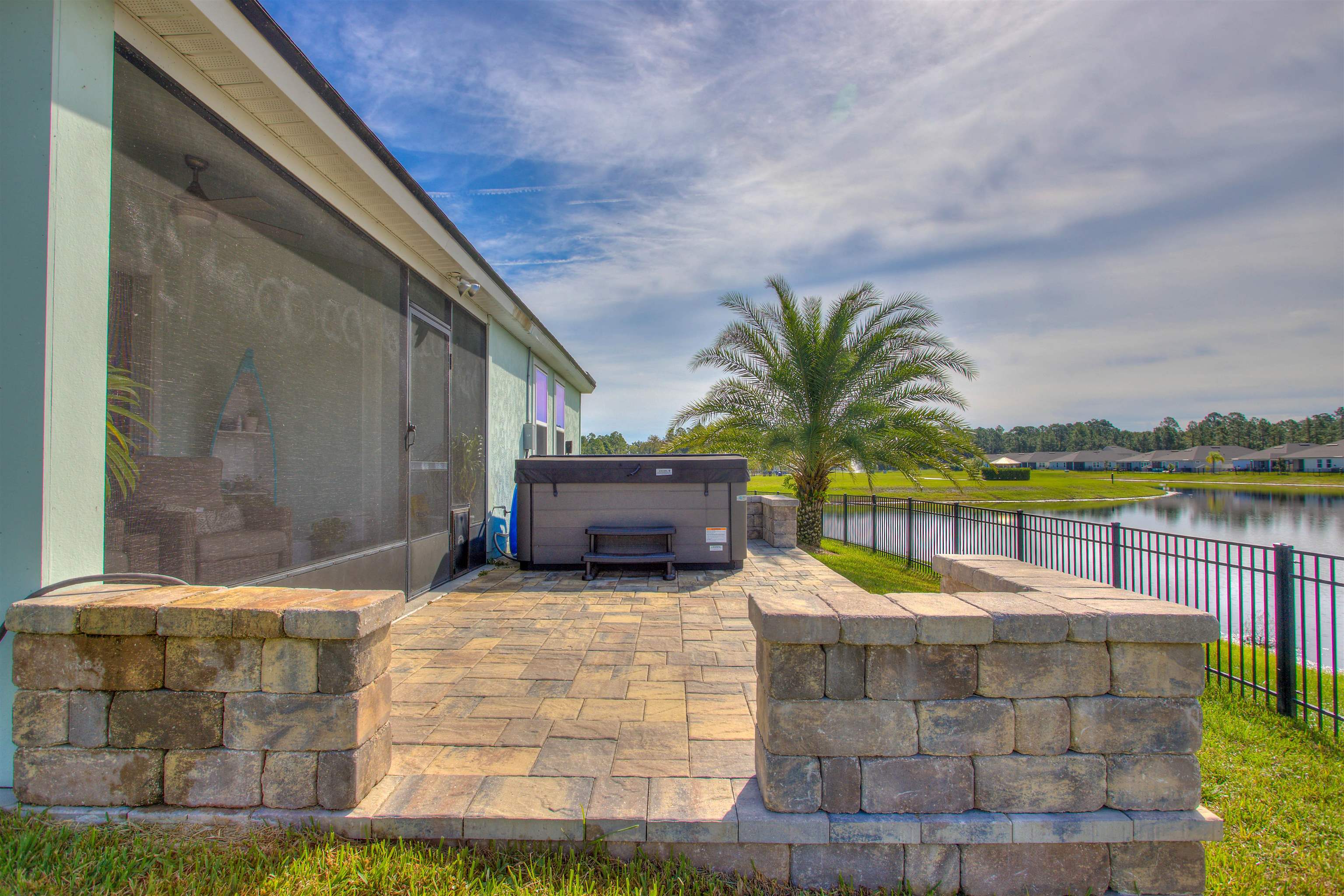 130 Huesca Court St. Augustine, FL 32084 - Photo 34 of 63 Fenced backyard featuring a water view, a hot tub, and a patio