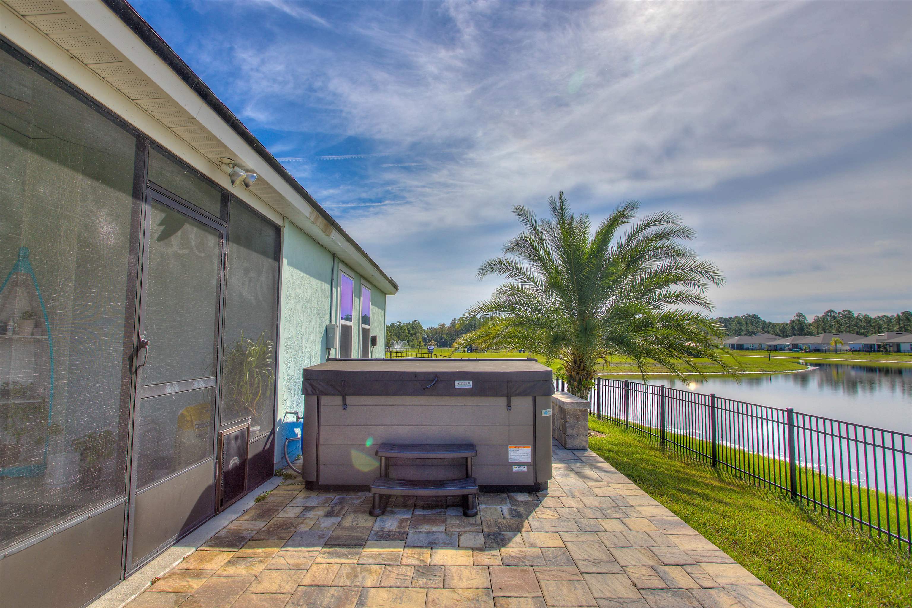 130 Huesca Court St. Augustine, FL 32084 - Photo 35 of 63 Fenced backyard featuring a hot tub, a patio, and a water view