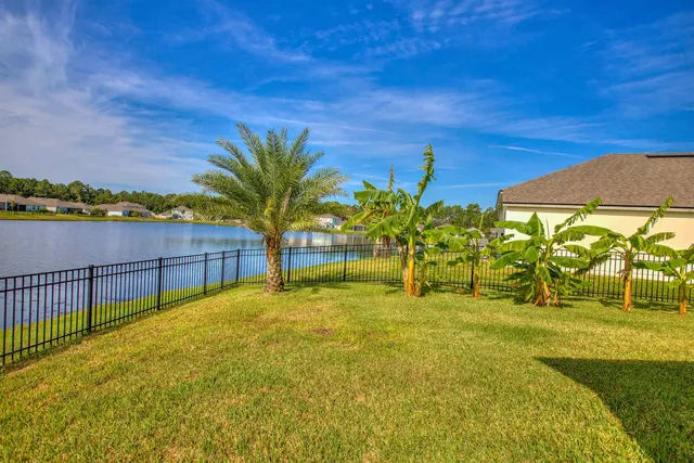 an aerial view of a swimming pool with outdoor seating