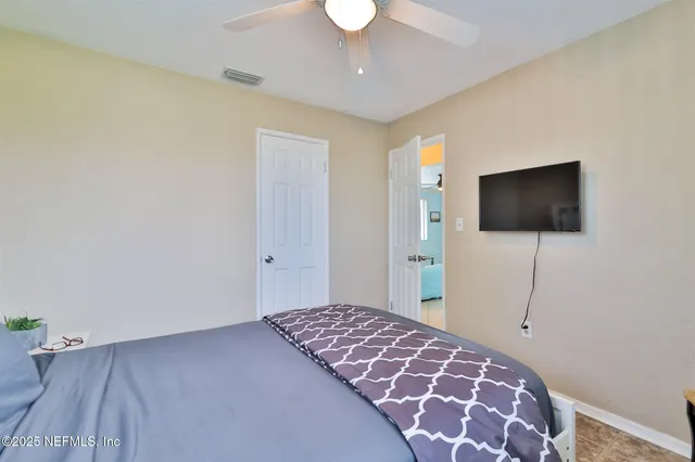a bedroom with a bed and a flat screen tv