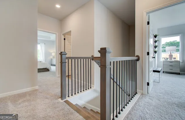 a view of a hallway with a door and stairs