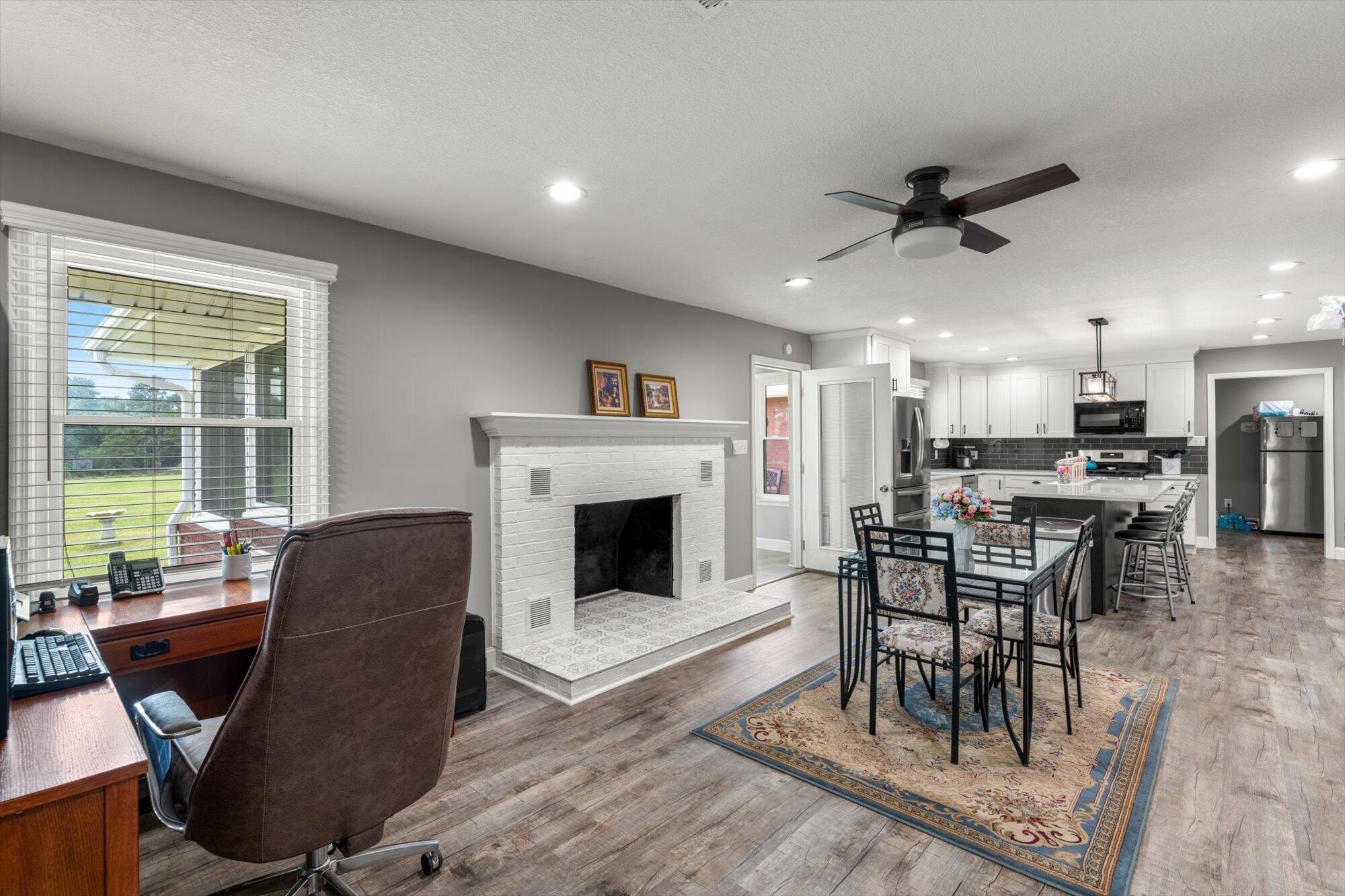 137 County Road 146 Riceville, TN 37370 - Photo 17 of 58 a living room with furniture a fireplace and a floor to ceiling window