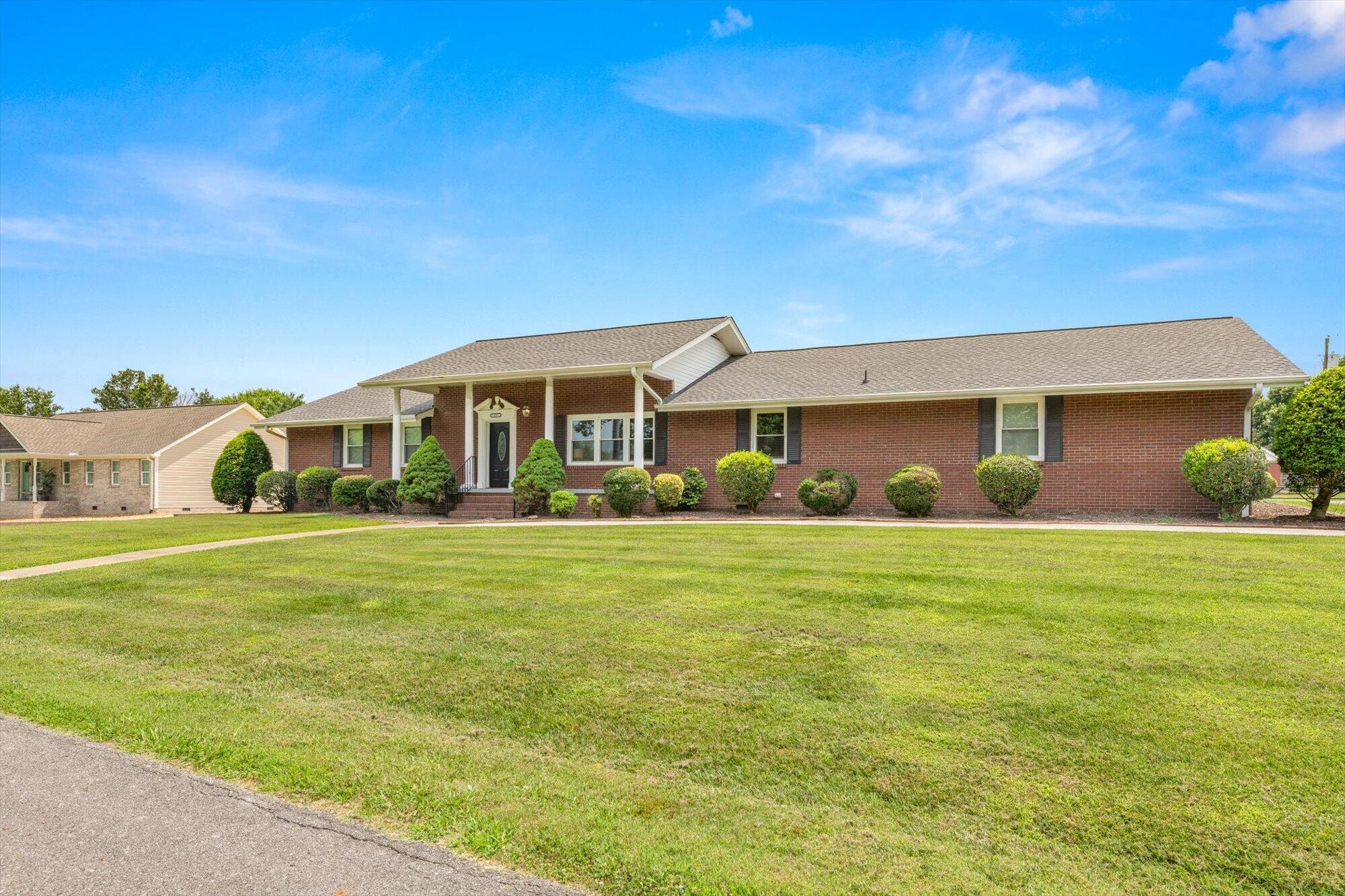 137 County Road 146 Riceville, TN 37370 - Photo 3 of 58 a front view of a house with a garden