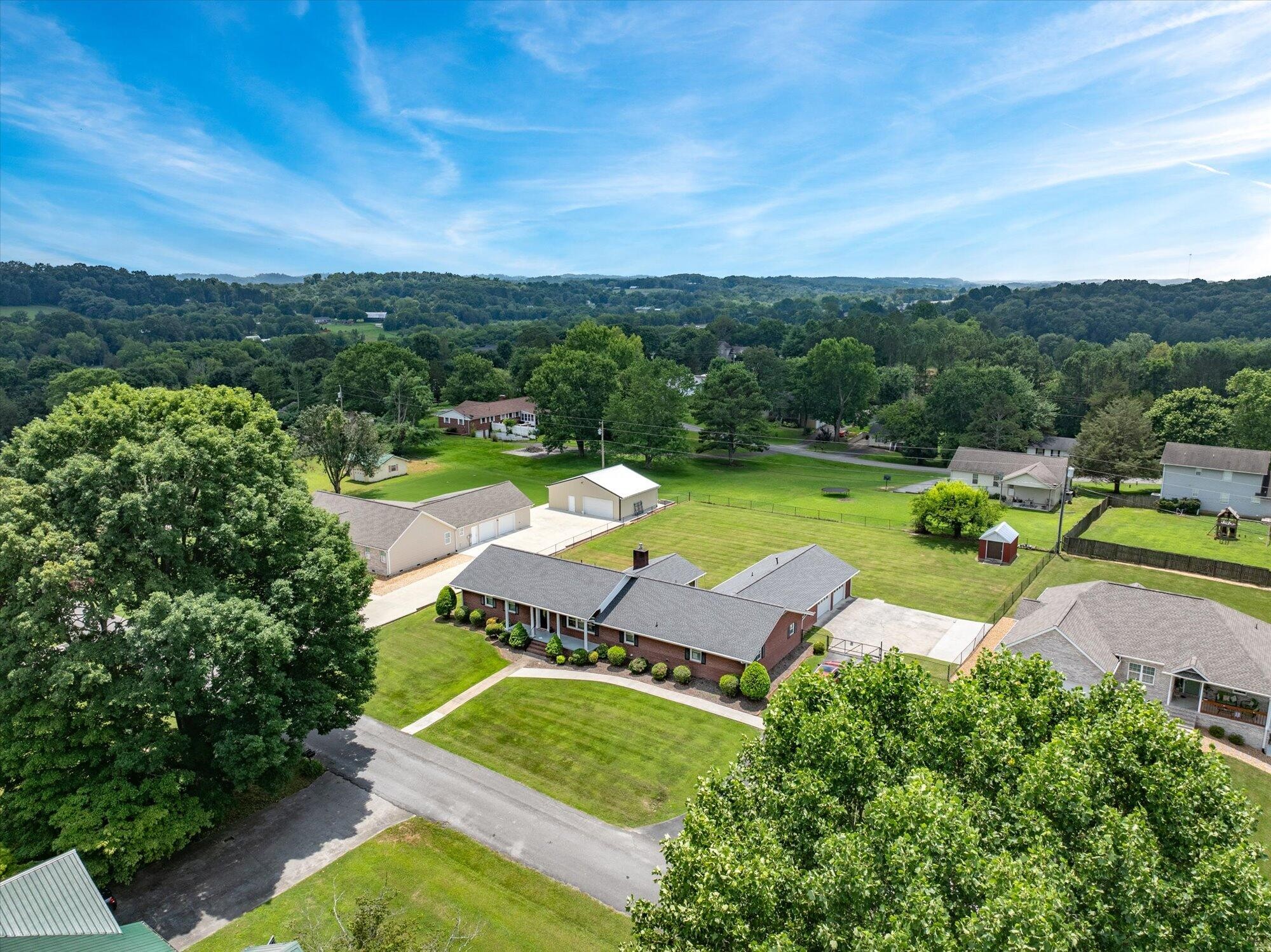 137 County Road 146 Riceville, TN 37370 - Photo 57 of 58 an aerial view of a house with garden space lake view and mountain view in back