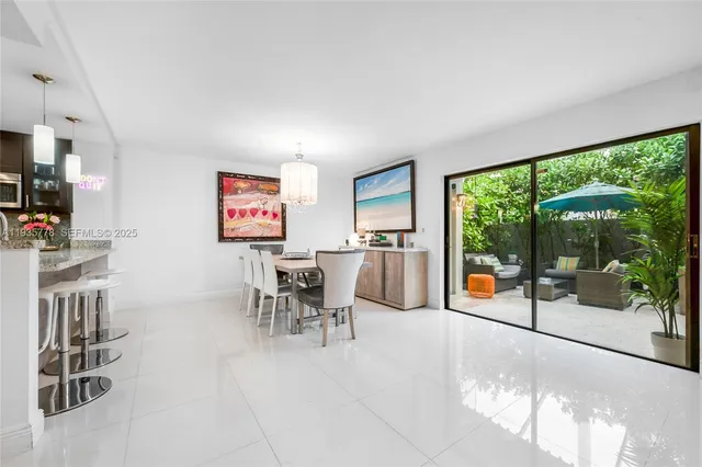 a view of a dining room with furniture water view and a garden view
