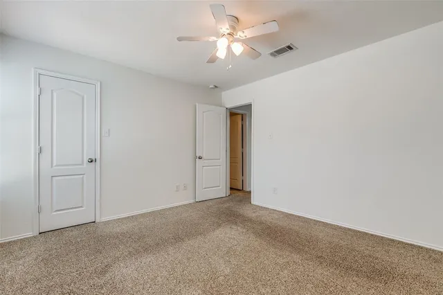 a view of a room with a ceiling fan and a chandelier fan
