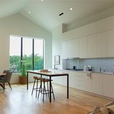 a kitchen with a table chairs and a sink