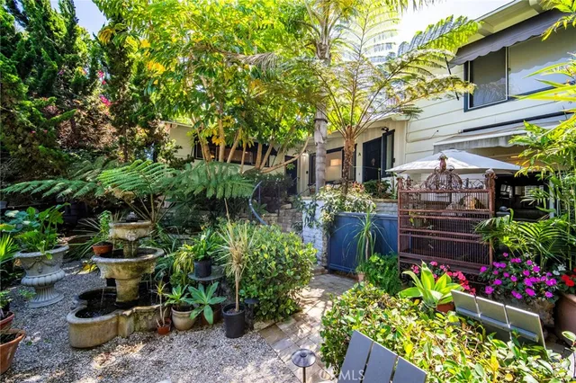 a view of a sitting area with lots of potted plants