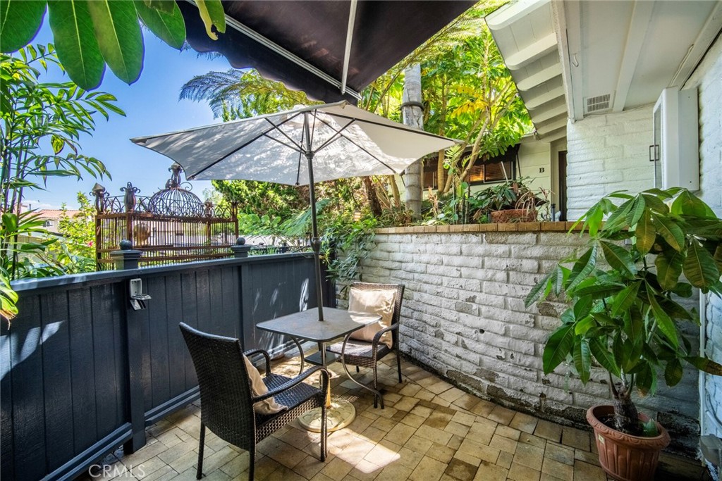33915 Robles Drive, Unit B Dana Point, CA 92629 - Photo 2 of 22 a patio with a patio table and chairs