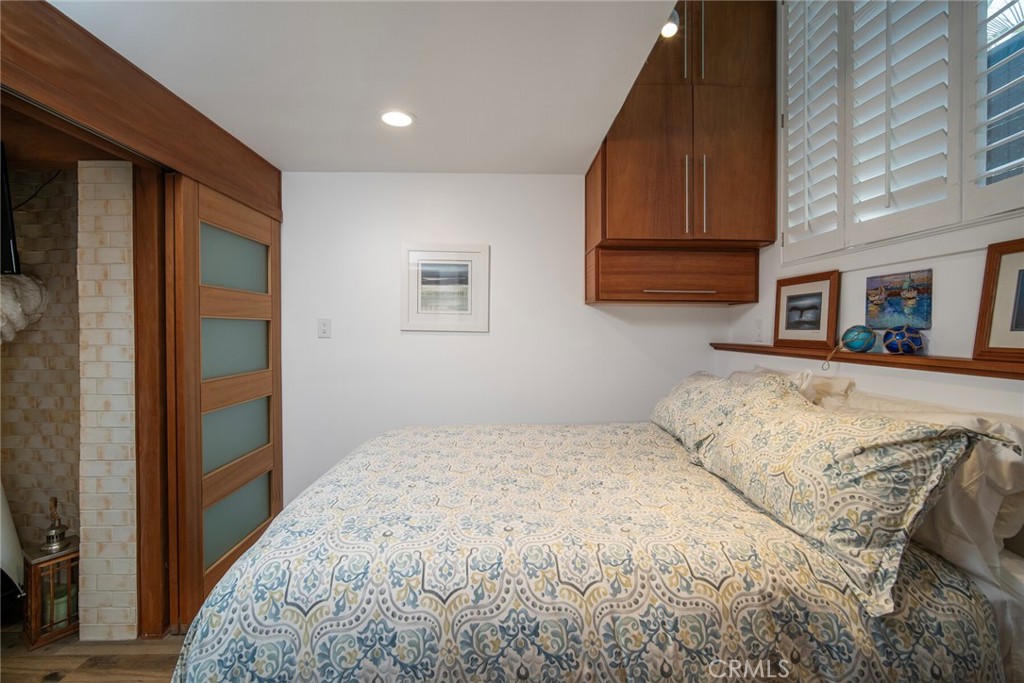 33915 Robles Drive, Unit B Dana Point, CA 92629 - Photo 8 of 22 a bedroom with a bed and a painting on the wall