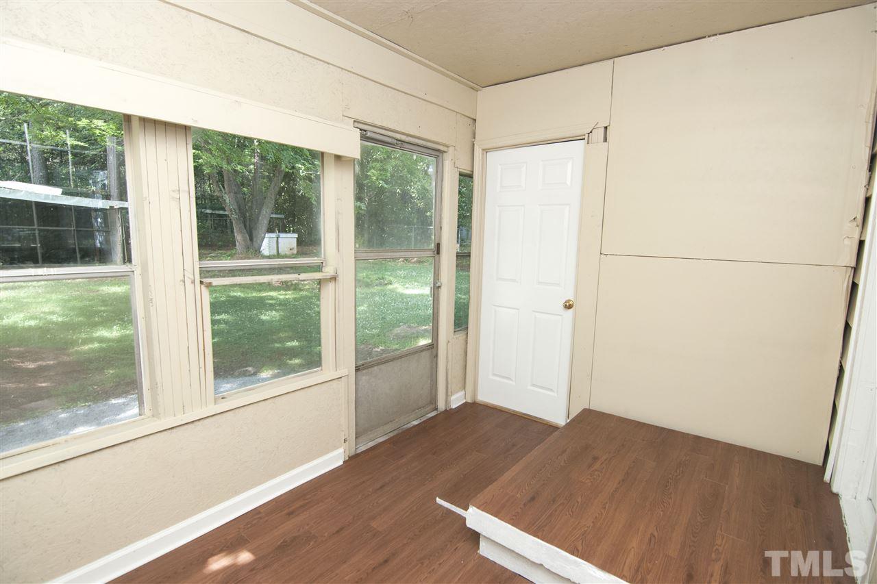 436 Raleigh View Road Raleigh, NC 27610 - Photo 22 of 25 an empty room with wooden floor and windows