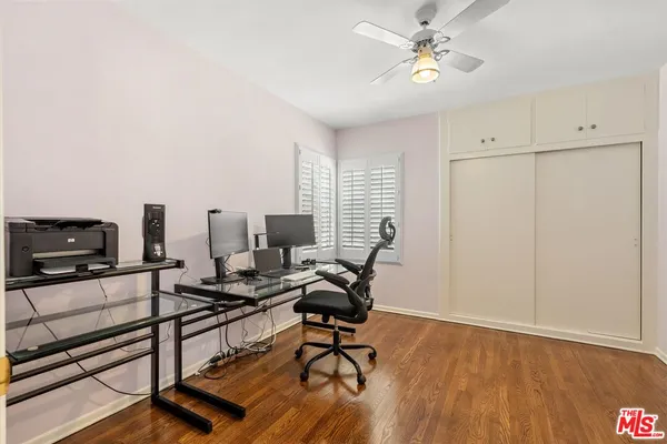 a view of a workspace with furniture and a window