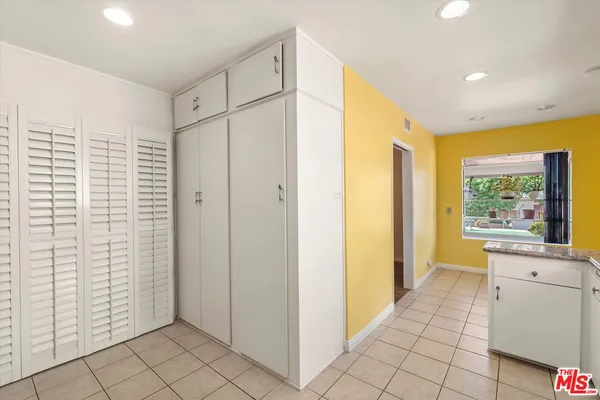 a view of a hallway with bathroom and shower