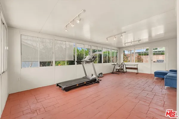 a room with gym equipment and large window