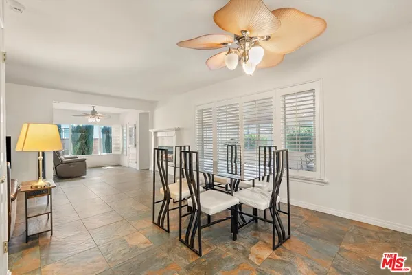 a view of a dining room with furniture wooden floor and chandelier