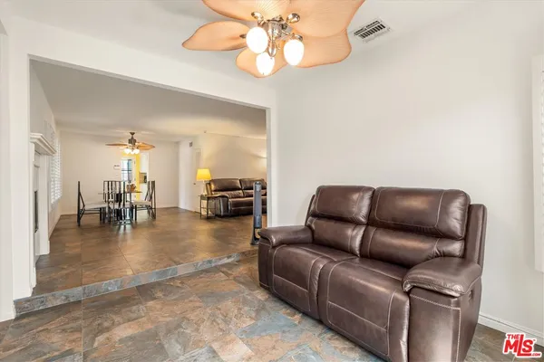 a living room with furniture and a dining table