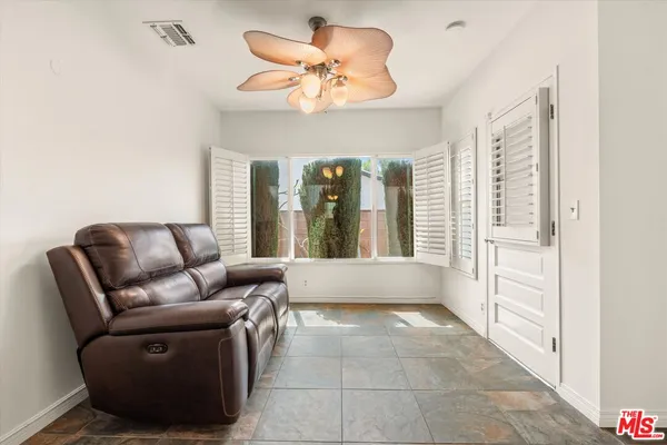 a living room with furniture and a large window
